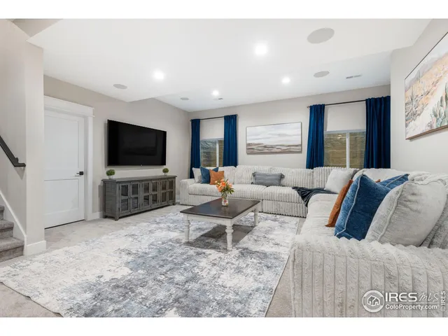 a kitchen with stainless steel appliances kitchen island granite countertop a sink a stove a dining table and chairs