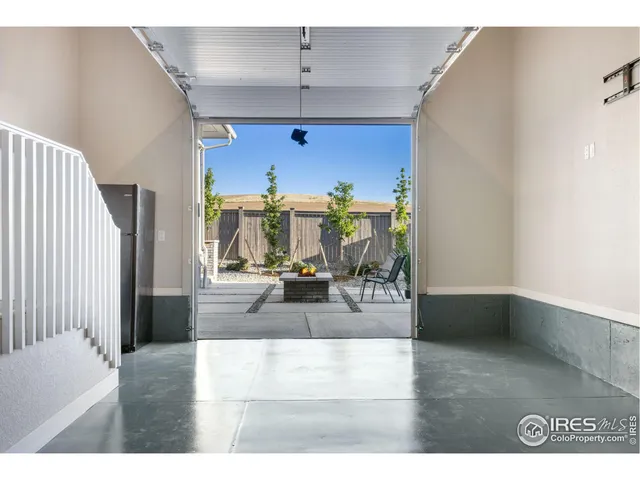 a living room with furniture a rug and a potted plant
