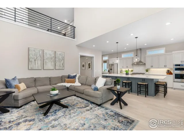 a living room with furniture and kitchen view
