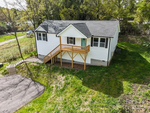 a aerial view of a house with swimming pool next to a yard