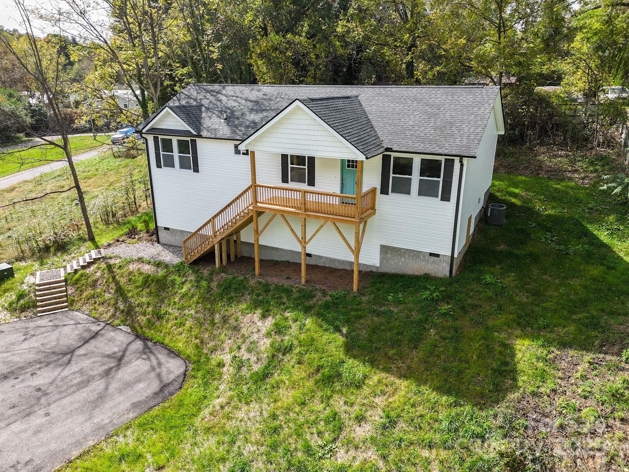 12 Holcombe Road Candler, NC 28715 - Photo 3 of 37 a aerial view of a house with swimming pool next to a yard