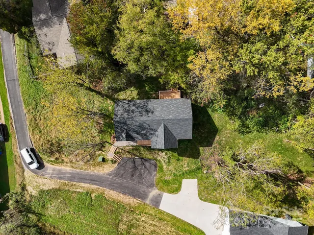 a house with green field in front of it