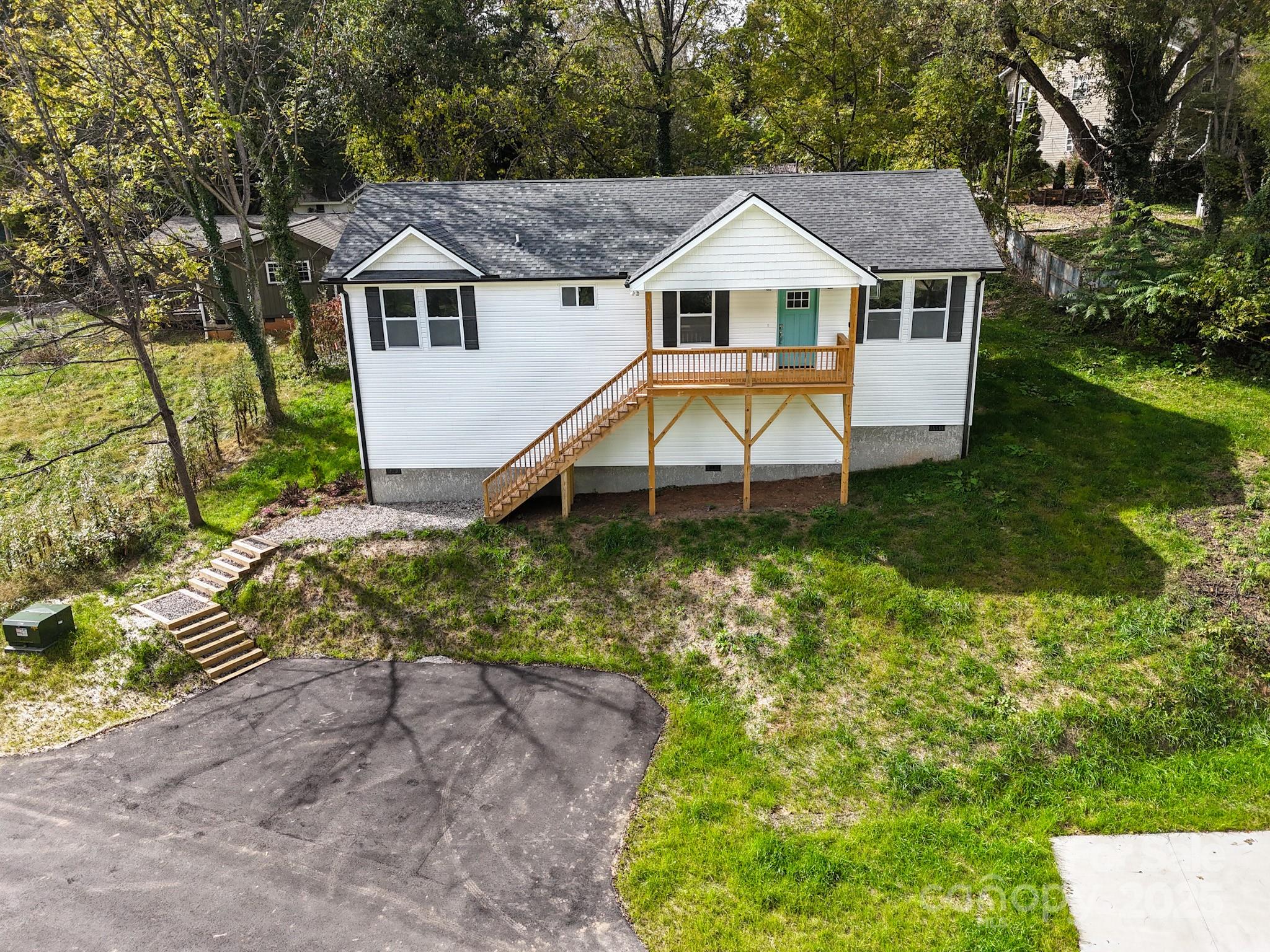 12 Holcombe Road Candler, NC 28715 - Photo 37 of 37 a house with green field in front of it