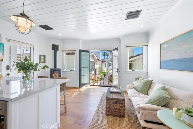 a living room with furniture a chandelier and a window