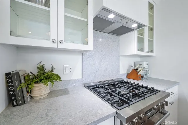 a kitchen with a table and potted plant
