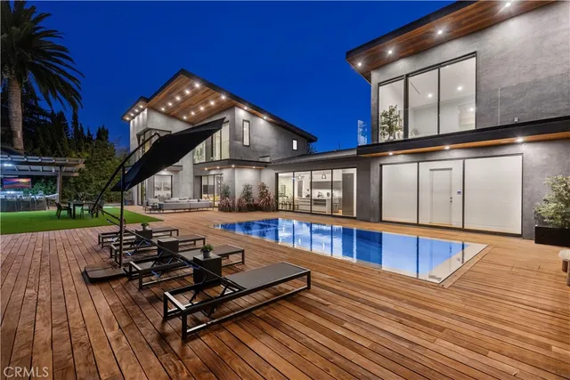 a view of a house with swimming pool and sitting area