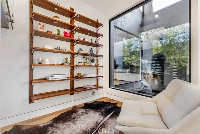a living room with furniture a rug and white walls