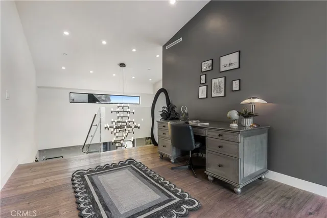 a room with gym equipment and wooden floor