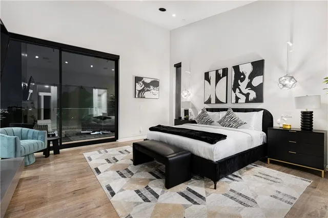 a bedroom with a bed and a glass top table