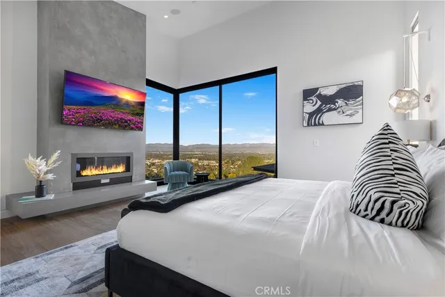 a bedroom with a bed and a fireplace