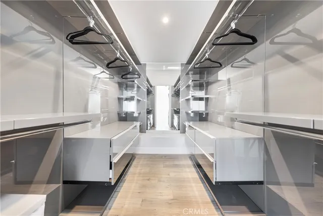 a large white kitchen with sink and windows