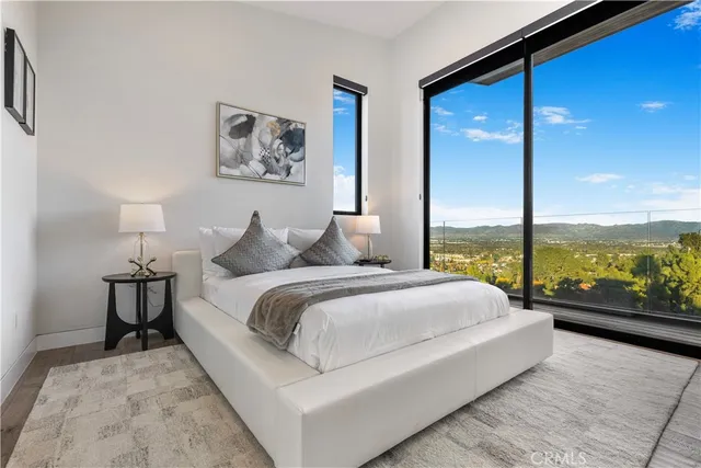a living room with a bed and large window