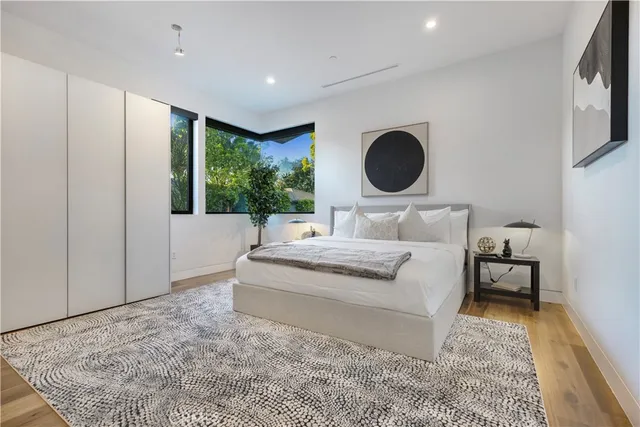 a bedroom with a large bed and a window