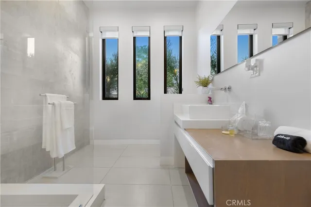 a bathroom with a tub sink and mirror