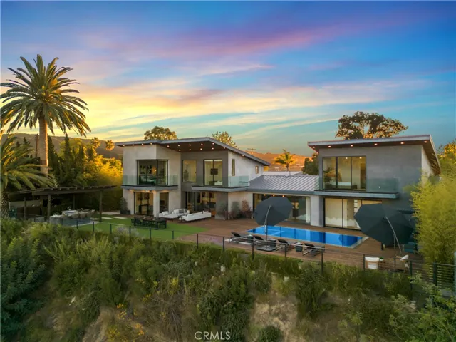 a front view of a house with a yard table and chairs