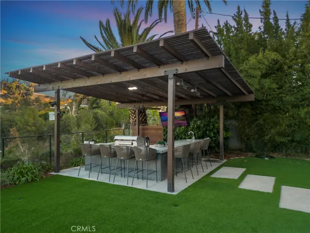 a view of a patio with table and chairs under an umbrella
