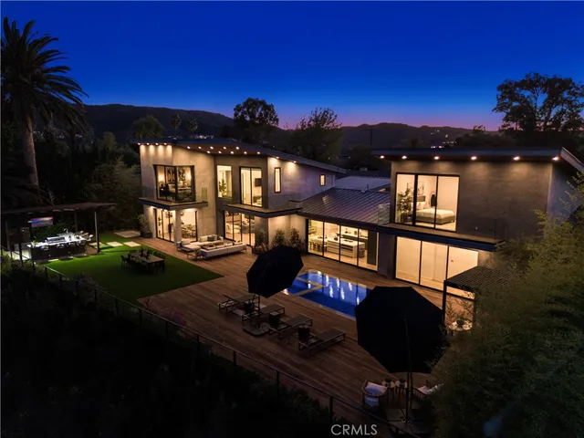 a backyard of a house with table and chairs