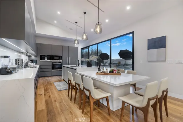 a kitchen with a dining table and chairs