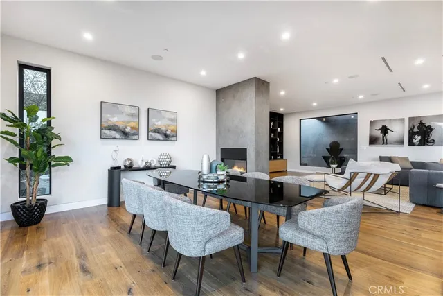 a dining room with furniture and wooden floor