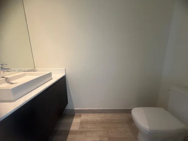 a bathroom with a sink toilet and mirror
