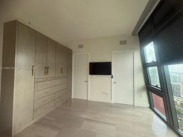 a view of a livingroom with an empty space and a hallway