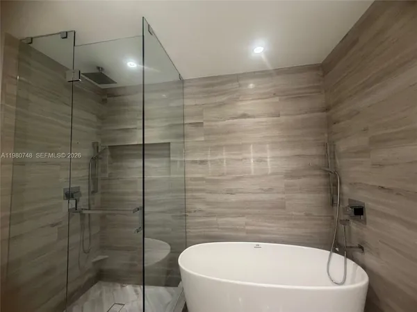 a bathroom with a bathtub and shower