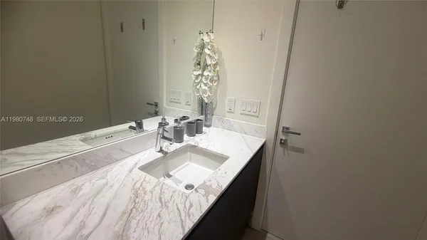 a bathroom with a sink and a mirror
