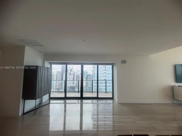a view of an empty room with glass door