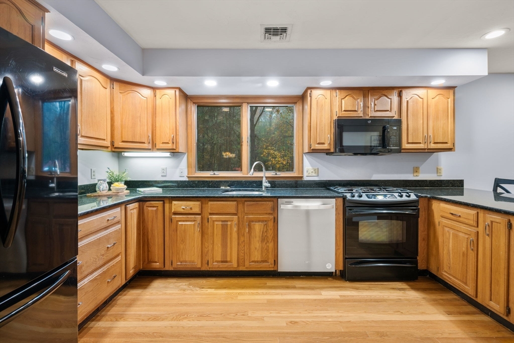 47 Ashcroft Road Sharon, MA 02067 - Photo 6 of 24 a kitchen with stainless steel appliances granite countertop a stove a sink and a microwave