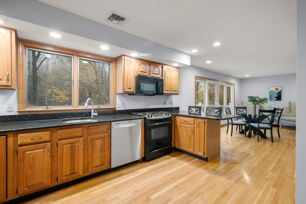 47 Ashcroft Road Sharon, MA 02067 - Photo 8 of 24 a kitchen with stainless steel appliances granite countertop sink stove top oven and cabinets