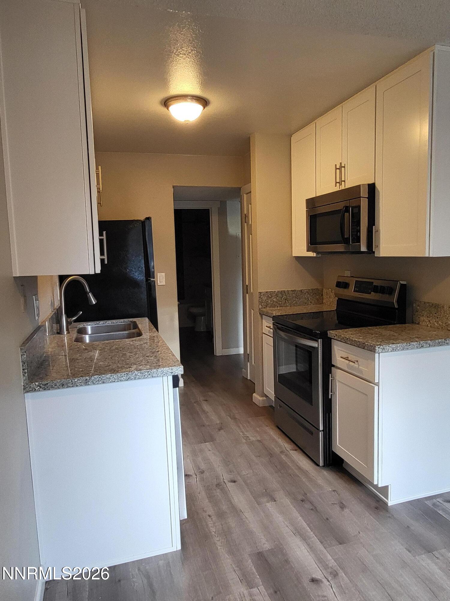 4606 Neil Road, Unit 197 Reno, NV 89502 - Photo 20 of 26 a kitchen with a sink and a stove top oven