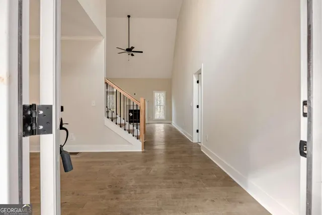 a view of empty room with wooden floor