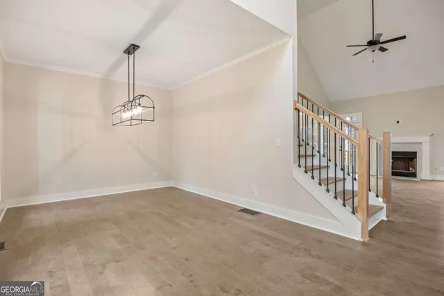 a view of a room with wooden floor and windows