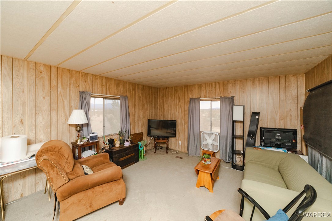 2565 Hopi Road Golden Valley, AZ 86413 - Photo 5 of 40 a living room with furniture and a flat screen tv