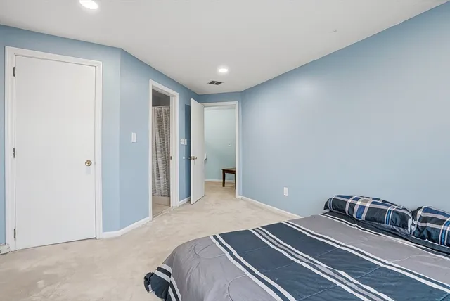 a bedroom with a bed and a mirror