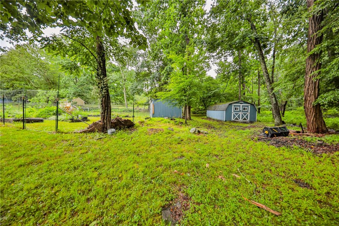 5599 Minks Pond Road Bushkill, PA 18324 - Photo 50 of 64 Discover two versatile outbuildings nestled amidst a verdant, wooded landscape.