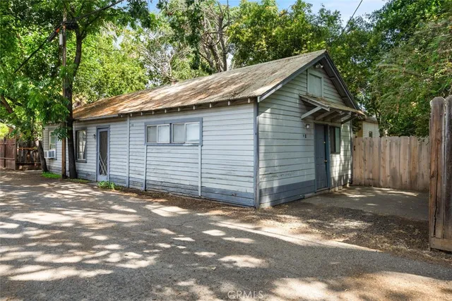 a view of a small house with a tree