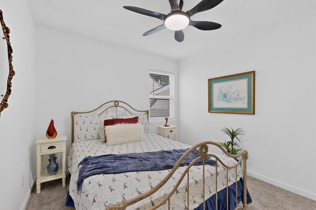 1202 Morrell Avenue Dallas, TX 75203 - Photo 12 of 33 a bedroom with a bed and a chandelier