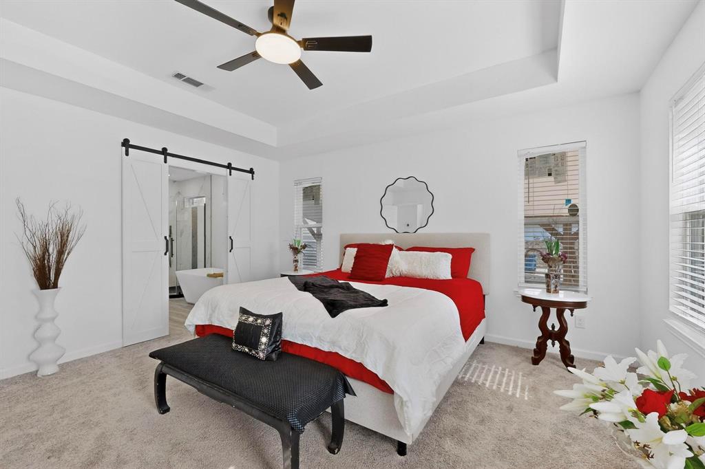 1202 Morrell Avenue Dallas, TX 75203 - Photo 15 of 33 a bed room with a bed and a chandelier