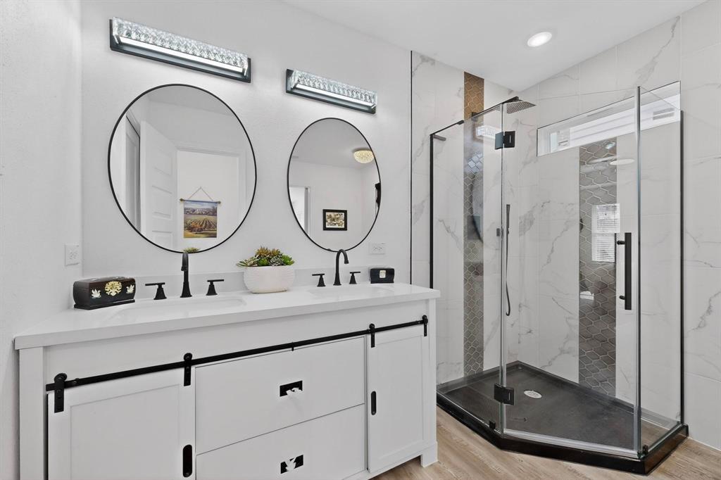 1202 Morrell Avenue Dallas, TX 75203 - Photo 16 of 33 a bathroom with a double vanity sink mirror and shower