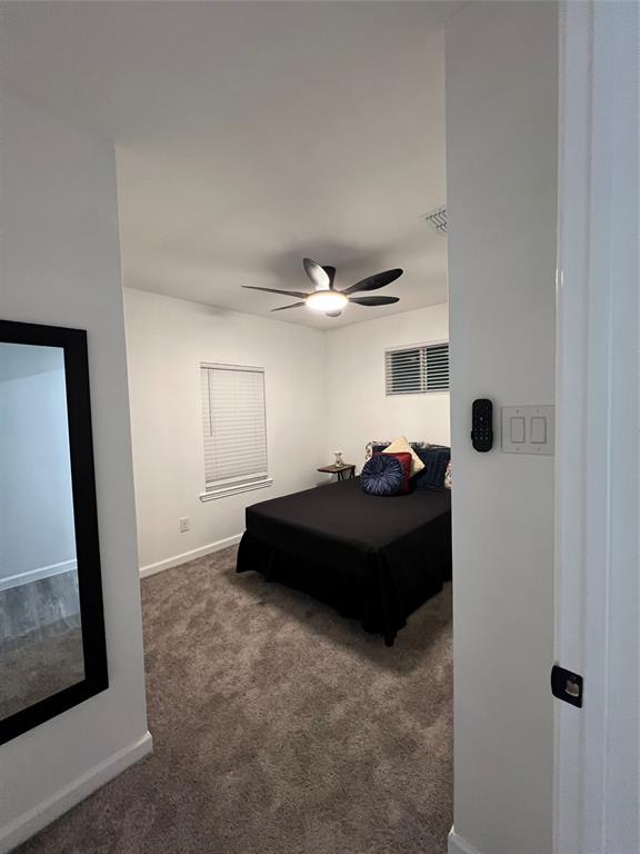 1202 Morrell Avenue Dallas, TX 75203 - Photo 23 of 33 a bedroom with a bed and a mirror
