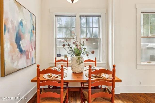 a dining room with furniture and wooden floor