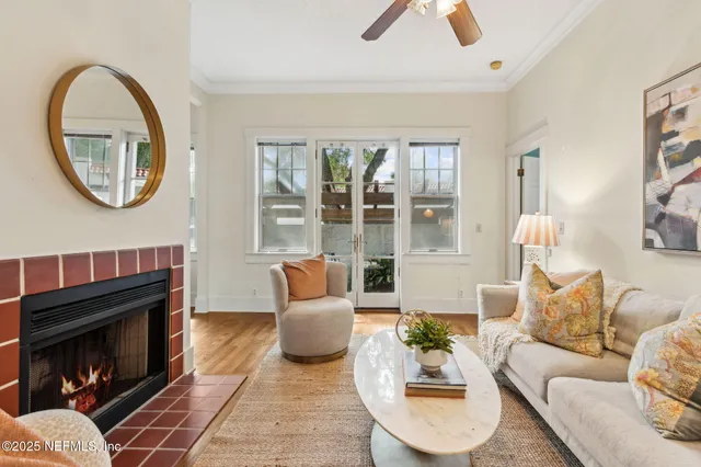 a living room with furniture a rug and a fireplace
