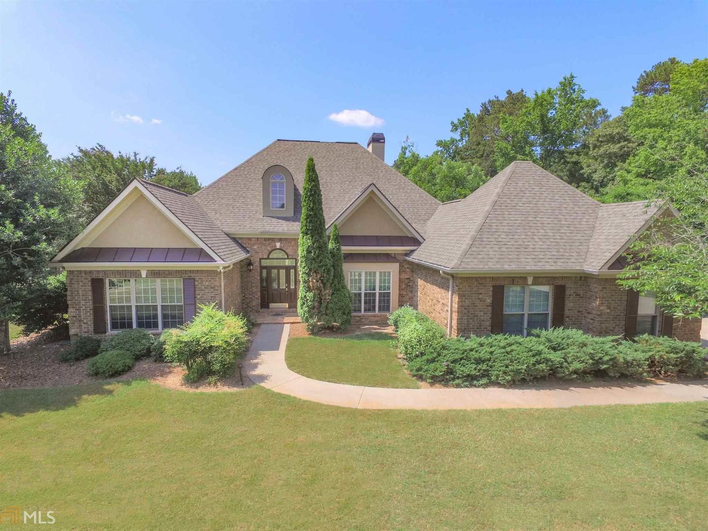 244 Quarters Road Fayetteville, GA 30215 - Photo 1 of 1 a front view of a house with a yard and garage