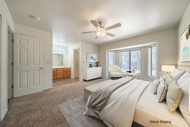 a spacious bedroom with a large bed a chandelier and closet