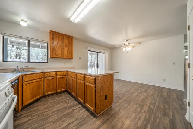 a kitchen with wooden floors and cabinets