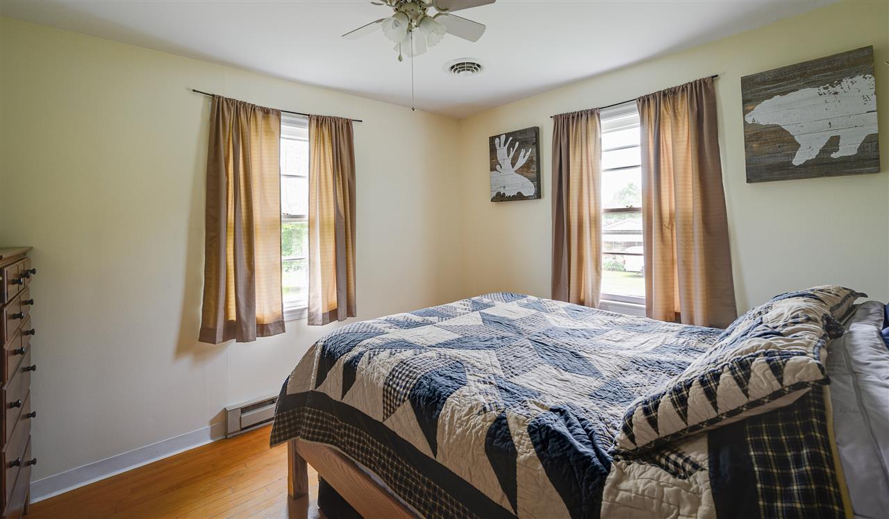 860 Fort Valley Road Fort Valley, VA 22652 - Photo 25 of 31 a bedroom with a bed and wooden floor
