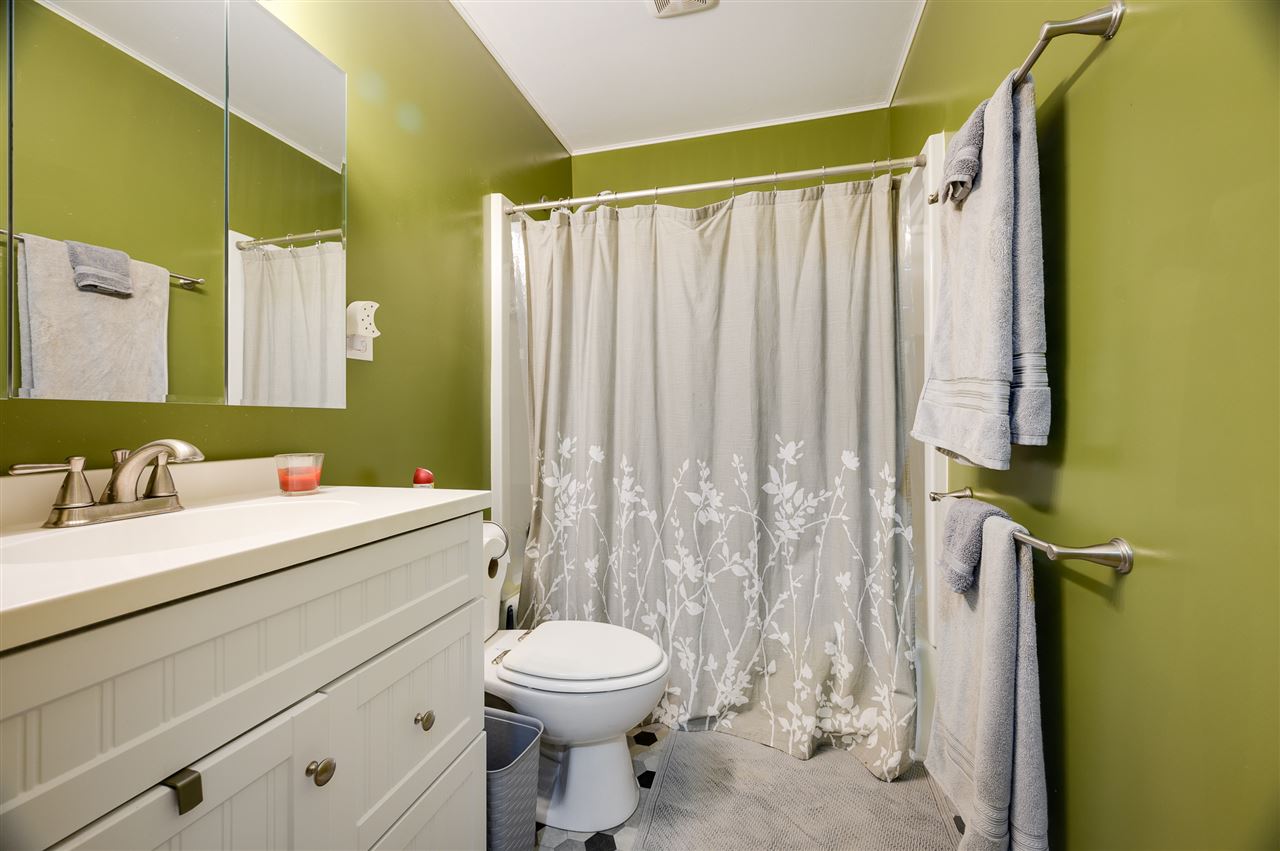 860 Fort Valley Road Fort Valley, VA 22652 - Photo 31 of 31 a bathroom with a white toilet sitting next to a sink and vanity