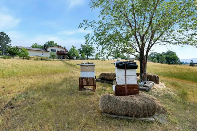 a view of a patio with table and chairs under an umbrella