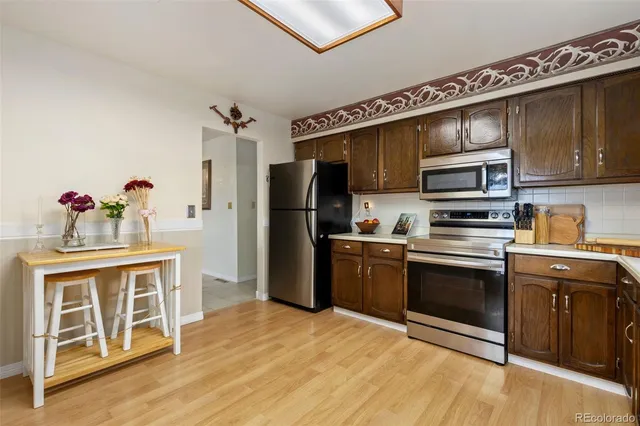 a kitchen with stainless steel appliances a stove a sink and a refrigerator